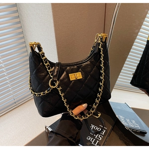Detail of black quilted hobo bag featuring a gold chain strap and square turn-lock