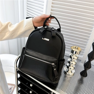 Chic black pebbled leather backpack for women with silver zippers and multi-pocket design