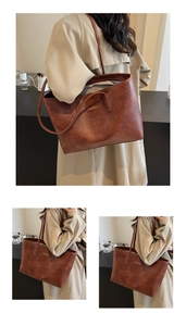 Close-up of vintage brown PU leather tote bag with elegant metal logo and slim straps