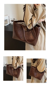 Detail of dark brown vintage faux leather tote with golden metal fashion plaque