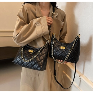 Comparison of two sizes of black quilted leather bags with gold chain straps and twist locks