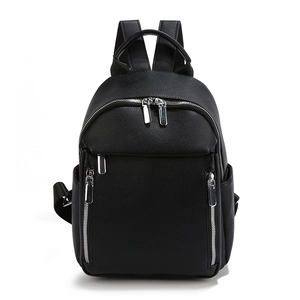 Minimalist black pebble leather backpack for women with silver zippers on white background