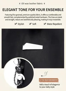 Water-repellent black oil wax leather detail with silver buckle and bear charm