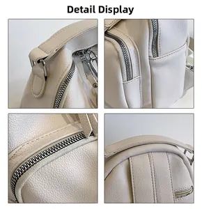 Detail view of white pebbled leather texture with silver zippers and stitching