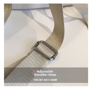 Detail of adjustable woven fabric shoulder strap with premium silver metal buckle