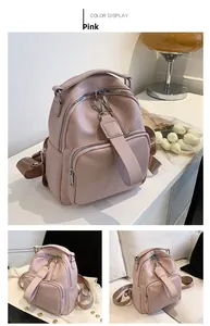 Close-up of pink textured faux leather backpack with silver hardware and front pocket