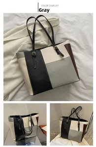 Detail of color-block tote bag in grey and neutral tones with adjustable shoulder strap