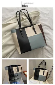 Close-up of color-block tote bag in blue, cream and black with premium leather texture