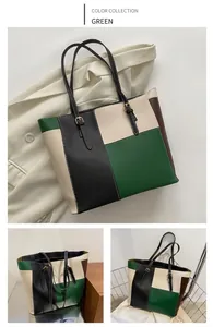Detail of a color-block tote bag in green, black, and beige with stylish buckle details