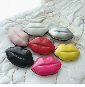 Detail showing glossy lip-shaped crossbody bags in multiple colors with gold metal chains
