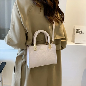 White faux-crocodile leather handbag with woven ring handle and gold hardware