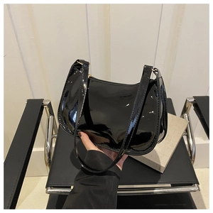 Primer plano de bolso baguette de charol negro con acabado brillante y asa fina