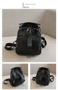 Detail view of black lychee grain PU leather backpack with silver metal zippers