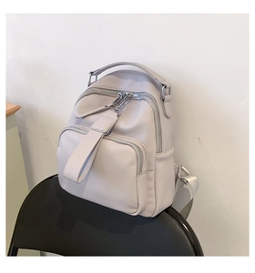 Close-up of litchi texture PU leather backpack for women with silver zippers and straps