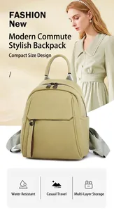 Detail of pea green faux leather backpack with layered zippers and water-resistant fabric
