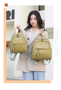 Size comparison of two olive yellow soft leather backpacks with silver zippers and fabric straps