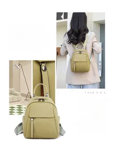 Detail of avocado green soft leather backpack with water-resistant litchi grain texture