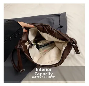 Detailed interior of the brown PU leather crossbody bag showing large storage capacity