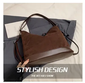 Detail of dark brown tote bag showing the contrast between suede and smooth leather texture