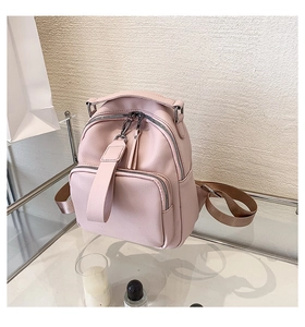 Close-up of pink PU leather mini backpack with textured finish and silver hardware
