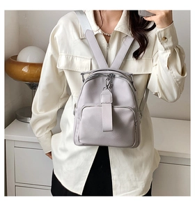 Detailed macro view of light purple PU leather backpack with lychee grain and zipper pocket