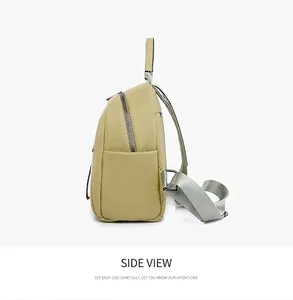 Side view of a soft green pebble leather backpack showing side pockets and silver zippers