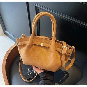 Details einer braunen Vintage-Wildleder-Einkaufstasche mit dekorativen Schnallen