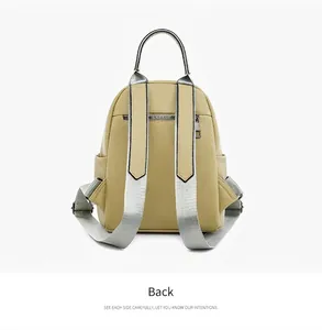 Back view of beige faux leather backpack showing silver straps and anti-theft zipper pocket