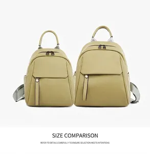 Size comparison of two mustard yellow grained leather backpacks with buckle detail