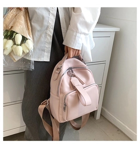 Pink lychee texture PU leather mini backpack featuring adjustable fabric straps and top handle