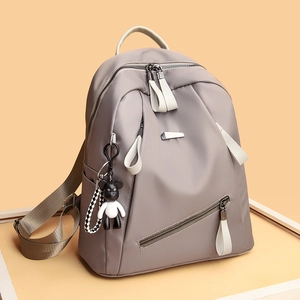 Women's minimalist grey nylon backpack with stylish functional zippers and bear charm