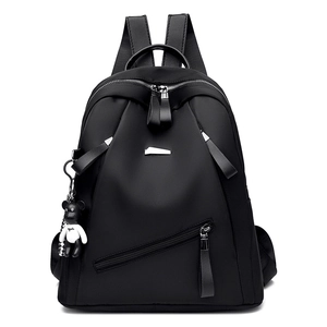 Minimalist black nylon large capacity backpack with silver zippers and bear charm