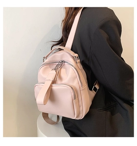 Pink minimalist PU leather mini backpack for women showing back straps and soft texture