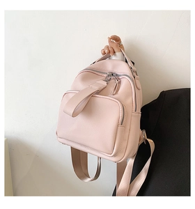 Detail of pink mini backpack in lychee grain leather with silver zippers and wide straps