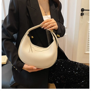 Close-up of white lychee pattern leather crescent bag with gold hardware and KO&SK logo