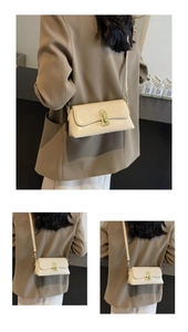 Détail du sac à bandoulière vintage crème en cuir brillant avec fermoir doré tournant