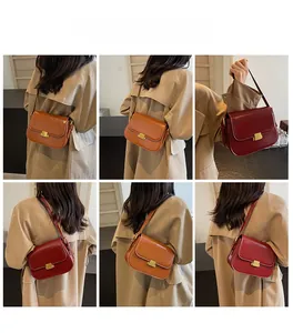 Detail of vintage leather crossbody bags in tan and dark red with gold square buckles