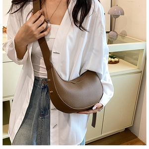 Brown lychee grain leather hobo bag featuring gold studs and matching wide strap detail