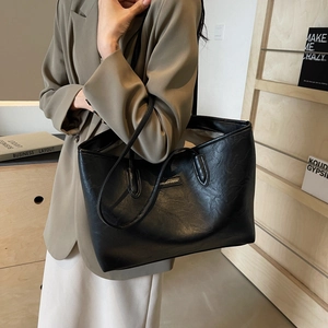 Black large capacity tote bag with dual straps and textured finish for daily commuting