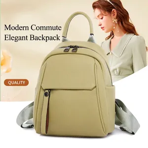 Modern light green faux leather backpack for women with pebbled texture and dual zippers