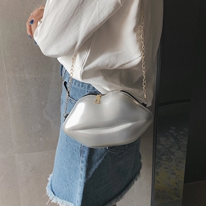 Chic metallic silver lip-shaped crossbody bag with a delicate gold chain strap for women