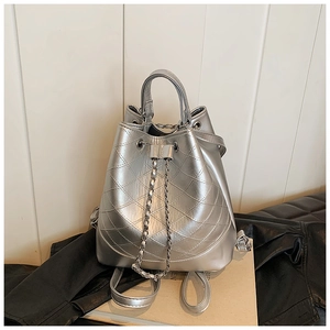 Detail of silver metallic drawstring bucket bag with quilted rhombic pattern and chain strap