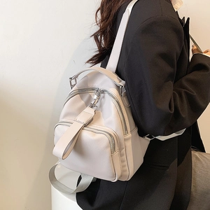 Light grey pebble leather backpack for women with minimalist urban style and large capacity