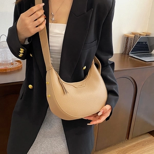 Chic beige hobo saddle bag in lychee pattern leather with stylish wide shoulder strap