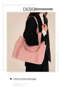 Close-up of pink large capacity canvas tote bag with decorative straps for women