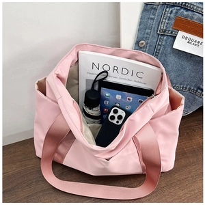 Pink canvas tote bag showing interior storage capacity for magazines and tablets
