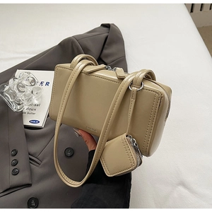 Detail of beige faux leather tote bag with detachable coin purse and silver zipper
