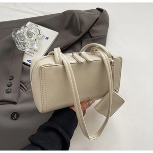 Minimalist cream leather pillow handbag with double handles and small accessory pouch