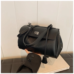Detail of black lychee grain leather handbag featuring silver twist lock and chic leather tag