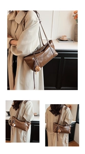 Detail of a brown PU leather shoulder bag with fine stitching and creative baseball charm